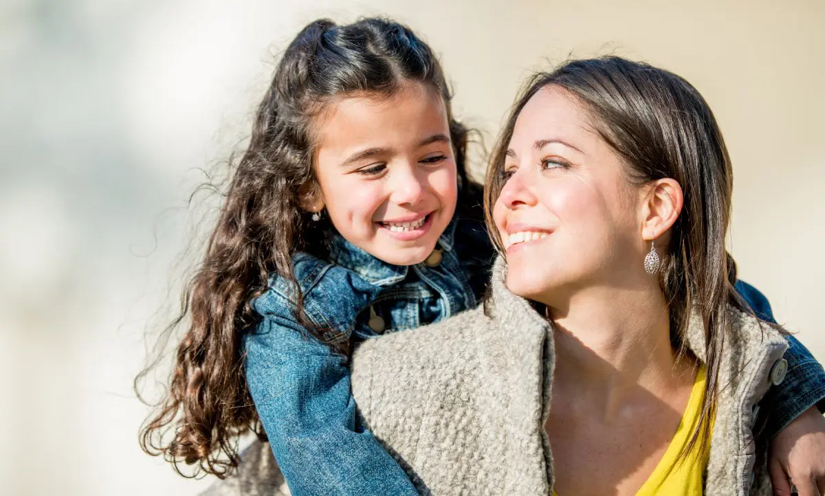 A mother and daughter outside in winter.