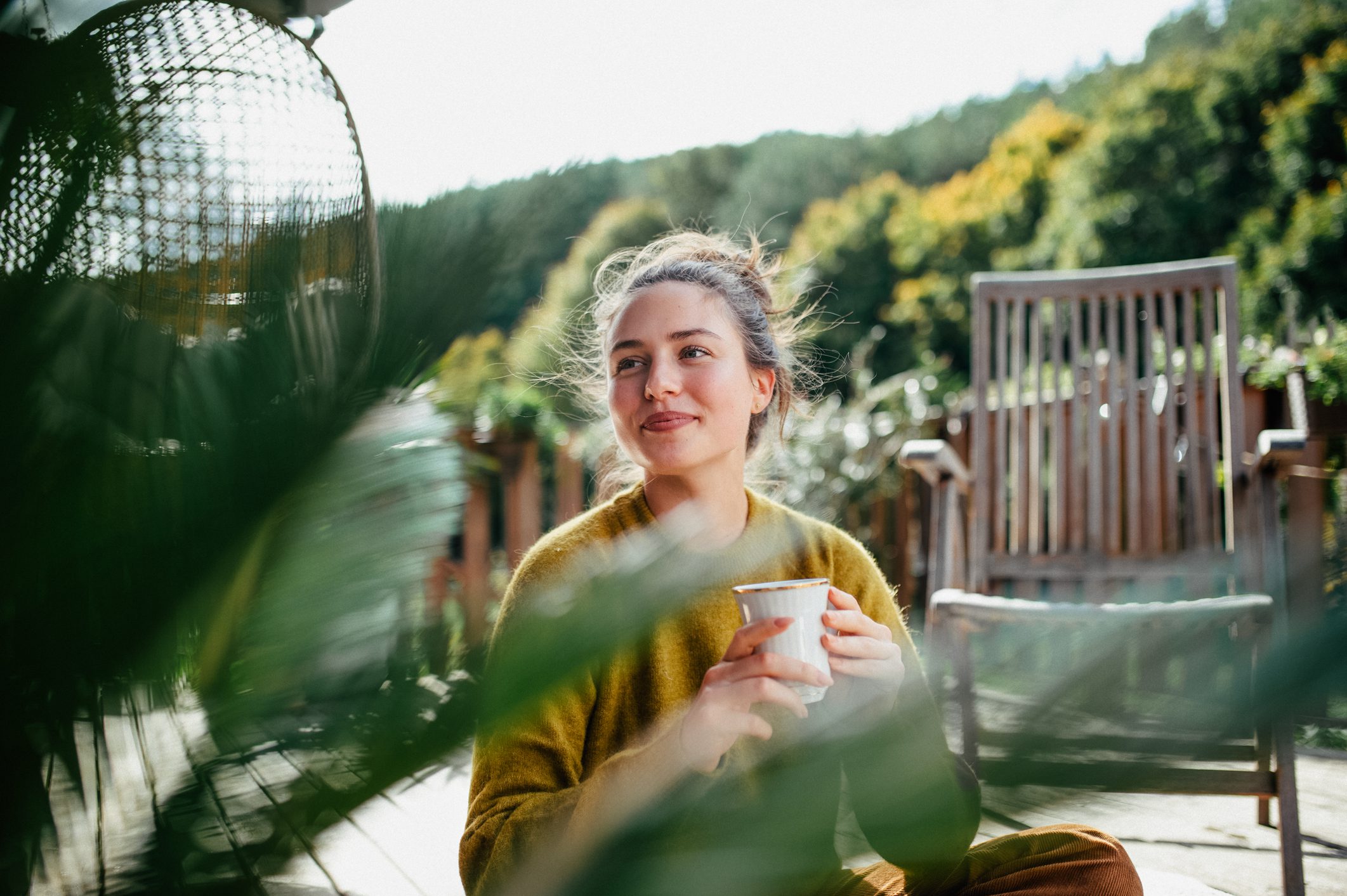 Woman looking out into greenery.